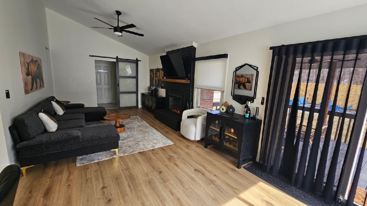 Family room with smart motorized drapes, electric fireplace, and backyard access